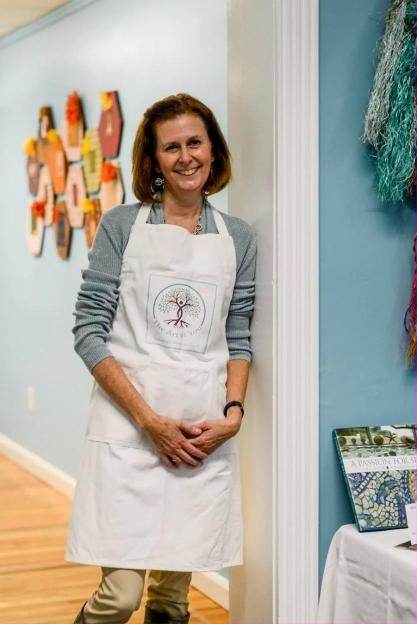 Brand photography of a shop owner in her apron