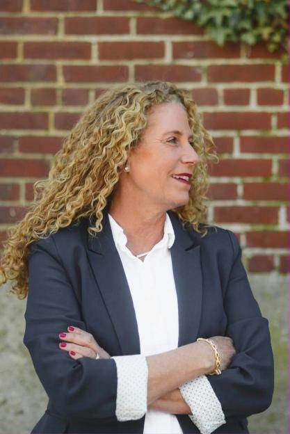 Professional headshot in front of a brick wall in Newport, Rhode Island
