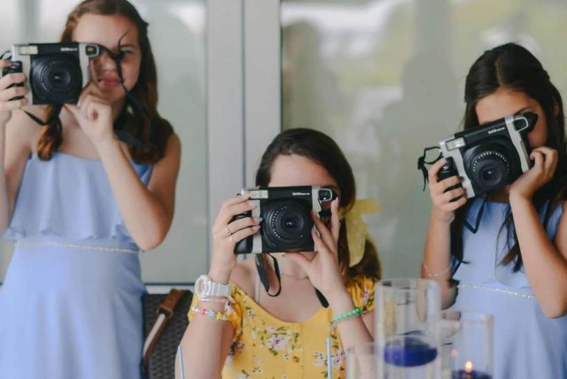 Guests taking photos with instant cameras at an event in Rhode Island