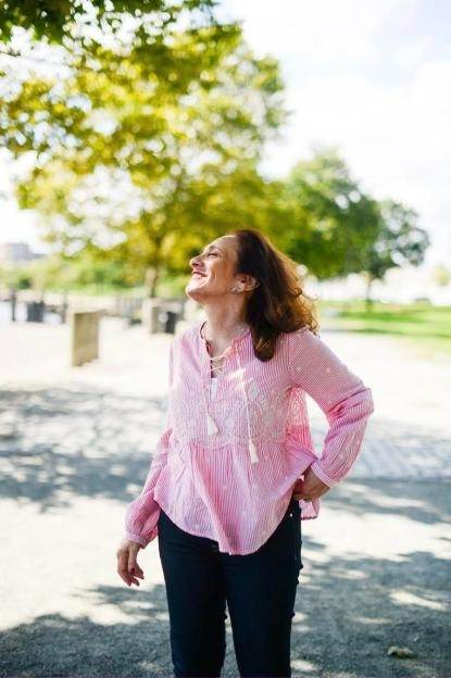 Joyful brand portrait of a woman laughing outdoors