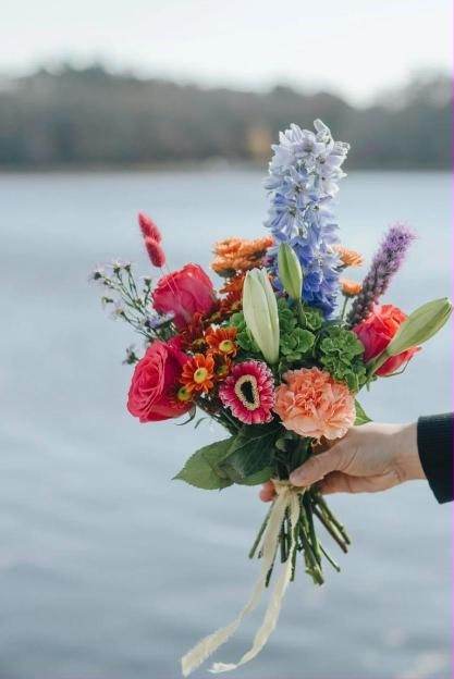A bouquet of flowers held over the water in Bristol, Rhode Island